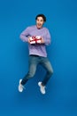 excited young man levitating with gift Royalty Free Stock Photo