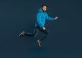 Excited Young Man Man Jumping In Air On Blue Background Royalty Free Stock Photo