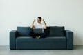 Excited young man using laptop computer while sitting on a sofa at home Royalty Free Stock Photo