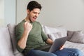 Excited young man using laptop Royalty Free Stock Photo