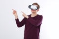 Excited young man in a VR headset, glasses pointing by fingers to the air. Virtual reality isolated on white background. Royalty Free Stock Photo