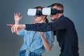 Excited young man and woman having fun with a VR glasses