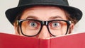 Excited young nerd guy holding book. Nerd in glasses. Funny man looking to camera. Never too late to study. Amazing man has great Royalty Free Stock Photo