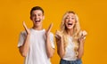 Excited young people rejoice success, happily screaming at camera