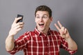 Excited young sportsman making v-sign for victory on selfie