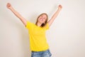 Excited young teenager girl standing isolated over white background with hands up. People, teen, emotions, expressions, success, Royalty Free Stock Photo