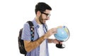 Excited young traveler with globe