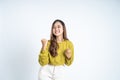 Excited young woman clenching hands while celebrating success