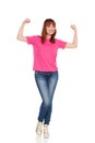 Excited Young Woman Is Flexing Muscles And Smiling