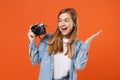Excited young woman girl in casual denim clothes posing isolated on orange background studio portrait. People lifestyle Royalty Free Stock Photo
