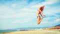 Excited young woman having fun on beach in summer Royalty Free Stock Photo