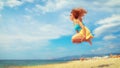 Excited young woman having fun on beach in summer Royalty Free Stock Photo