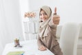 Excited young woman with hijab smiling to camera and showing thu Royalty Free Stock Photo