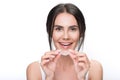 Excited young woman holding clear aligner