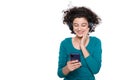 Excited young woman looking at her mobile phone smiling. Woman reading text message on her phone.