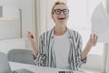 Excited young woman with paper bills in hands finally paying down her mortgage debt at home Royalty Free Stock Photo