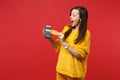 Excited young woman in yellow fur sweater hold wireless modern bank payment terminal to process and acquire credit card Royalty Free Stock Photo