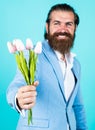 Excitement. man with beard and stylish hair. holiday and celebration. floral gift for mothers or womens day. happy man