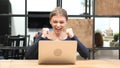 Excitement of Success by Girl working on Laptop, Front View