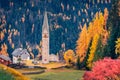 Exciting autumn long focus view of ruine San Genesio church