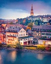 Exciting evening cityscape of Bern town with Cathedral of Bern on background. Spectacular autumn sunset on Switzerland, Aare River