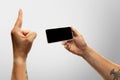 Close up male hands holding phone with blank screen during online watching of popular sport matches and championships Royalty Free Stock Photo