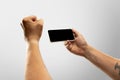 Close up male hands holding phone with blank screen during online watching of popular sport matches and championships Royalty Free Stock Photo