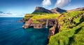 Exciting morning scene of Mulafossur Waterfall. Impressive summer view of Gasadalur village, Vagar, Faroe Islands, Denmark, Europe