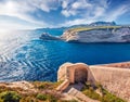 Exciting morning scene of ruins of old Bonifacio fortress with Madonetta Lighthouse on background.