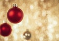 Exciting Red Christmas Baubles hanging in front of sparkling gold bokeh background