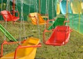 Exciting rides for children - swings, roundabout on the chains Royalty Free Stock Photo