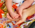 Young woman with the small feet of her baby in the hands Royalty Free Stock Photo