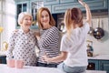 Little girl telling story to her mother and grandmother Royalty Free Stock Photo