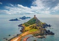 Exciting summer scene of popular tourist destination Torra di a Parata - 16th-century Genoese tower reached by a rocky nature trai