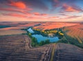 Exciting summer sunrise on Ternopil outskirts with two lakes and asphalt road on the midle. Royalty Free Stock Photo