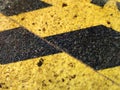 Exciting yellow and black graphic texture painted on rough surface.