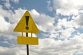 Exclamation point of attention on a yellow triangular sign with a sign for signing.