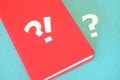 Exclamation and question mark on a red book