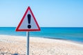 Exclamation triangle, warning sign, danger sign icon on the beach