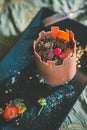 Exclusive chocolate cake like tower with fruits served on black plate, product photography for patisserie, dessert for castle
