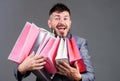 Exclusive commercial offer. Man bearded businessman customer carry many shopping bags. Enjoy shopping profitable deals