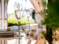 Exclusive decoration of the banquet table on the terrace in the luxury restaurant. A glass of expensive champagne on a Royalty Free Stock Photo