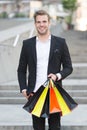 Exclusive shopping. Man shopper carries shopping bags urban background. Successful businessman choose only luxurious