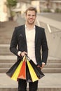 Exclusive shopping. Man shopper carries shopping bags urban background. Successful businessman choose only luxurious Royalty Free Stock Photo