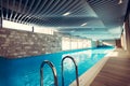 Exclusive swimming pool in a wellness hotel.Luxury resort indoor swimming pool with beautiful clean blue water Royalty Free Stock Photo