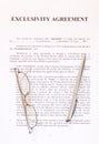 Exclusivity agreement form with pen and glasses Royalty Free Stock Photo