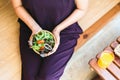 Excretory good system concept,Woman hand holding and eating healthy salad for breakfast in the morning Royalty Free Stock Photo