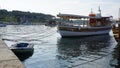 Excursion boat anchored next small boat Royalty Free Stock Photo