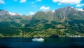 Excursion boat cruising across the Norwegian fjord Royalty Free Stock Photo