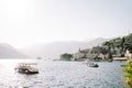 Excursion boats bob on the waves while moored off the coast in the Bay of Kotor. Perast, Montenegro